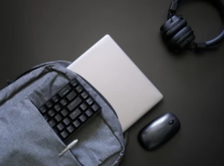 Best Laptop Accessories - laptop, keyboard, mouse and headphones unpacked from a laptop bag