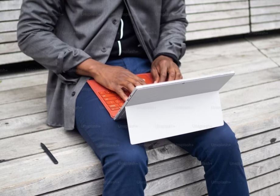 Best Tablets of 2025 - a man was typing on a tablet at the bus top while waiting for bus/