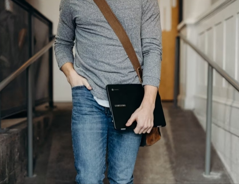 Best Tablets of 2025 - a man walking with his tablet in hand and a wearing a gray long sleeve shirt