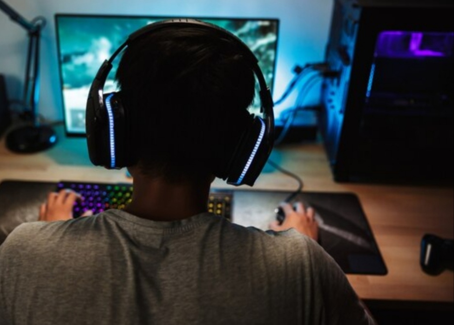 best gaming headsets 2025 - man playing games with headphones